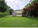 A detached garage with a concrete block foundation and a yellow garage door at 1922 Salem Church Rd, Lincolnton, NC 28092