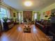 Inviting living room with a brick fireplace, hardwood floors, and a cozy leather sofa at 1922 Salem Church Rd, Lincolnton, NC 28092