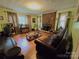 Spacious living room with a brick fireplace, hardwood floors, and ample natural light at 1922 Salem Church Rd, Lincolnton, NC 28092