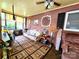 Sun room with exposed brick, colorful rug, and a ceiling fan at 1922 Salem Church Rd, Lincolnton, NC 28092