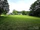 Vast yard with lush grass and mature trees offers ample space and privacy at 1922 Salem Church Rd, Lincolnton, NC 28092