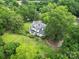 Aerial shot of a grand home nestled among mature trees, showcasing its expansive grounds and serene location at 206 Rose Ter, Wadesboro, NC 28170