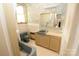 Retro bathroom with blue fixtures, floral wallpaper, and vintage charm at 206 Rose Ter, Wadesboro, NC 28170