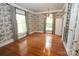 Bright bedroom with hardwood floors, large windows, and decorative wallpaper at 206 Rose Ter, Wadesboro, NC 28170