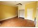 Empty bedroom with yellow walls, wood floors, and a built in cabinet at 206 Rose Ter, Wadesboro, NC 28170