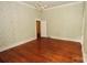 Bedroom featuring a chandelier, original hardwood floors, and vintage wallpaper at 206 Rose Ter, Wadesboro, NC 28170