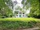 Picturesque home showcasing a grand facade, lush greenery, and mature trees, creating a serene setting at 206 Rose Ter, Wadesboro, NC 28170