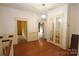 Bright hallway with hardwood floors and glass doors leading to additional rooms at 206 Rose Ter, Wadesboro, NC 28170