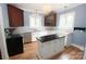 Kitchen featuring an island, stainless steel appliances, and vintage cabinets for ample storage at 206 Rose Ter, Wadesboro, NC 28170