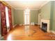 Spacious living room showcasing a fireplace, hardwood floors, and a bright chandelier at 206 Rose Ter, Wadesboro, NC 28170