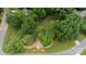 Aerial view of a spacious lot with mature trees and lush green surroundings at 211 Southfork Dr, Belmont, NC 28012