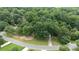 Aerial view of a charming home nestled amidst lush greenery and mature trees at 211 Southfork Dr, Belmont, NC 28012