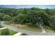 Aerial view of a charming home nestled amidst lush greenery and mature trees at 211 Southfork Dr, Belmont, NC 28012