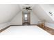Expansive attic with ample storage space, hardwood floors, ceiling fan, and bright natural light at 211 Southfork Dr, Belmont, NC 28012