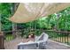 Cozy back deck with shaded seating and a variety of potted plants for a serene outdoor space at 211 Southfork Dr, Belmont, NC 28012