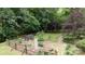 Secluded backyard featuring stone pathway, split rail fence, and mature trees at 211 Southfork Dr, Belmont, NC 28012
