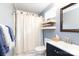 Cozy bathroom featuring a blue vanity, shelving and toilet with marble-look floors at 211 Southfork Dr, Belmont, NC 28012