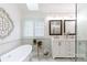 Bright bathroom features a soaking tub and double vanity with marble countertops and stylish decor at 211 Southfork Dr, Belmont, NC 28012