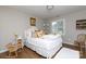Bedroom with white bed, wood floors, neutral colored walls, and natural light at 211 Southfork Dr, Belmont, NC 28012
