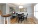 Cozy dining area with stylish decor, featuring a black round table and hardwood floors at 211 Southfork Dr, Belmont, NC 28012