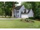 Charming two-story home featuring a spacious lawn, two car garage, and well-maintained landscaping at 211 Southfork Dr, Belmont, NC 28012