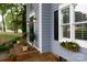 Exterior featuring a brick porch and window boxes overflowing with flowers adding curb appeal at 211 Southfork Dr, Belmont, NC 28012