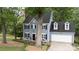 Charming home with a well-manicured lawn and mature trees creating a serene setting at 211 Southfork Dr, Belmont, NC 28012
