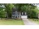 Charming two-story home with a well-manicured lawn and attached garage at 211 Southfork Dr, Belmont, NC 28012