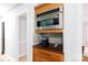 Elegant kitchen with built-in microwave, custom wood cabinetry, and stylish lighting, providing both functionality and style at 211 Southfork Dr, Belmont, NC 28012