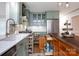 Modern kitchen with green cabinetry, an island, stainless steel appliances, and ample storage for cooking enthusiasts at 211 Southfork Dr, Belmont, NC 28012