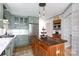Beautiful kitchen featuring sage cabinets, stainless steel appliances, and a wooden island for a warm and inviting space at 211 Southfork Dr, Belmont, NC 28012