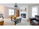 Bright living room with a brick fireplace, built-in shelving, and hardwood floors, creating a welcoming space at 211 Southfork Dr, Belmont, NC 28012
