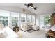 Bright and airy living room featuring large windows, a comfortable couch, and vaulted ceilings at 211 Southfork Dr, Belmont, NC 28012