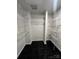Walk-in closet with white wire shelving and black tile floors at 2125 Southend Dr # 320, Charlotte, NC 28203