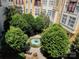 Charming courtyard view with lush greenery and a beautiful fountain, creating a serene outdoor space at 2125 Southend Dr # 320, Charlotte, NC 28203