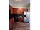 Kitchen features cherry cabinets, black appliances, and a stainless steel refrigerator at 2125 Southend Dr # 320, Charlotte, NC 28203