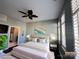 Bedroom featuring a large bed, hardwood floors, plantation shutters and a view to the bath at 2125 Southend Dr # 320, Charlotte, NC 28203