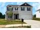 New two-story home featuring a two car garage, stone accents, and a well manicured lawn at 215 Lake George Dr, Shelby, NC 28152