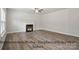 A bright living room featuring wood-look flooring and a cozy fireplace at 215 Lake George Dr, Shelby, NC 28152