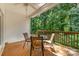 Relaxing back deck with table and chairs, offering a serene view of the surrounding trees and greenery at 2333 Wednesbury Ct, Kannapolis, NC 28083