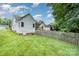 Side view of home, showcasing the large backyard, wood fence, and lush greenery at 2333 Wednesbury Ct, Kannapolis, NC 28083
