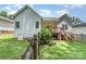 View of the home's backyard and wooden deck, surrounded by a well-maintained lawn and partial fencing at 2333 Wednesbury Ct, Kannapolis, NC 28083