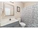 Well-lit bathroom with a gray vanity, patterned shower curtain, and a coordinating mirror and towel rack at 2333 Wednesbury Ct, Kannapolis, NC 28083