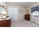 Charming bedroom with two dressers, a plush carpet, and a window with blinds providing warm, natural light at 2333 Wednesbury Ct, Kannapolis, NC 28083