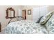 Comfortable bedroom featuring floral bedding, hardwood floors, and an ornate mirror, creating a cozy and inviting space at 2333 Wednesbury Ct, Kannapolis, NC 28083