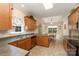 Kitchen with wood cabinets, stainless steel appliances, and eat-in dining area at 2333 Wednesbury Ct, Kannapolis, NC 28083