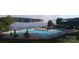 Community pool and clubhouse area with lounge chairs and dining tables overlooking a misty lakefront at 237 Roxboro Dr, Mount Gilead, NC 27306