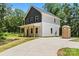 Charming two-story home boasts a welcoming front porch with wood columns and a modern two-tone facade at 25 Mickley Ave, Bessemer City, NC 28016