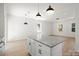 Modern kitchen features a large island with granite countertops, white cabinets and stainless steel appliances at 25 Mickley Ave, Bessemer City, NC 28016