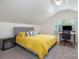 Bedroom with a yellow coverlet, desk, and window views at 255 South Academy St, Mooresville, NC 28115